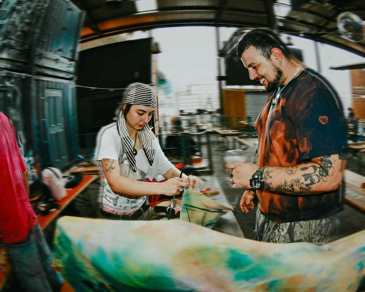 Crew members hand-painting festival banners at the site.